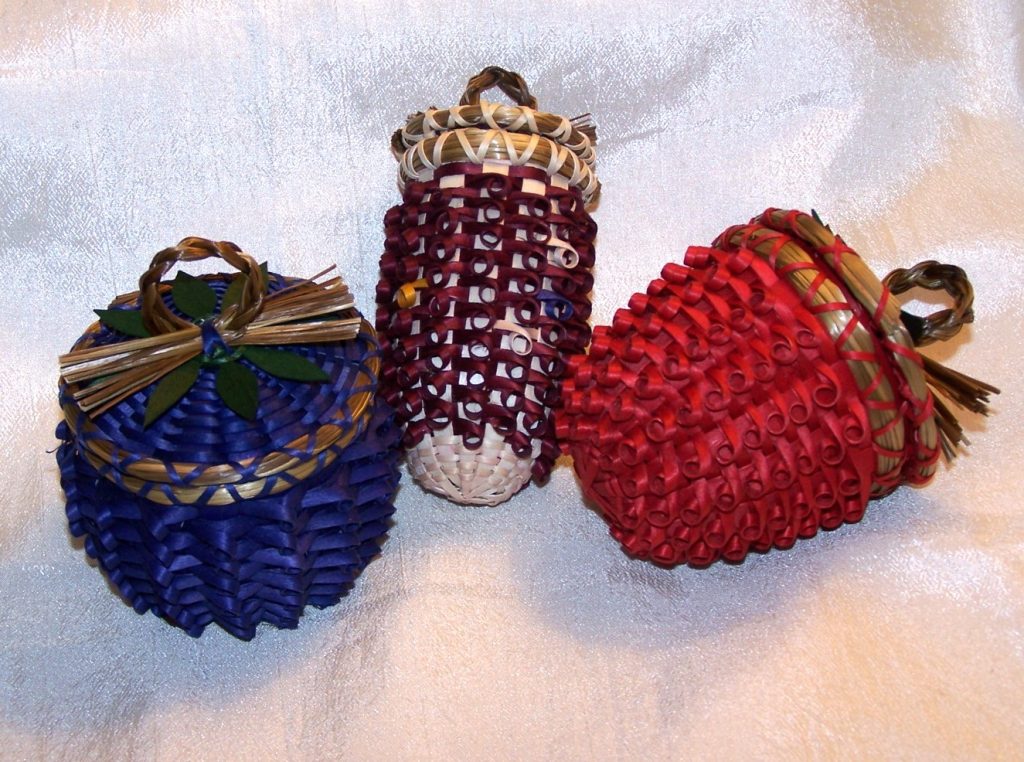 Group of three baskets shaped like a plum, corn, and a strawberry