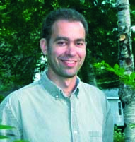 Image of Caucasian man standing outside in collared shirt.