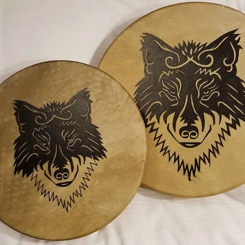 Image of two drums with stylized drawings of wolves.