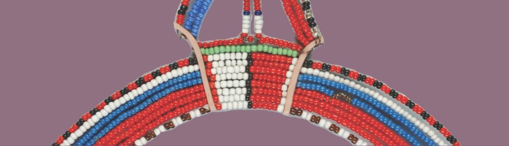 Detail image of a beaded object with red, white, blue, green, and black beads.