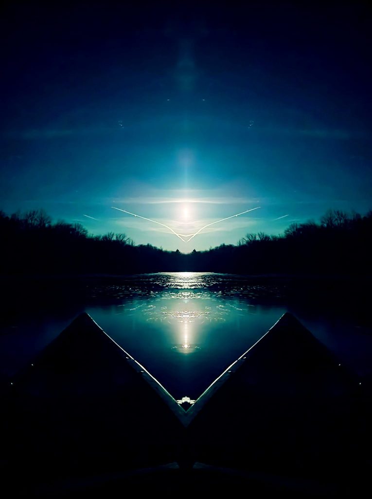 Sample of artist's photography: themes of water reflecting moonlight past the bow of a canoe.