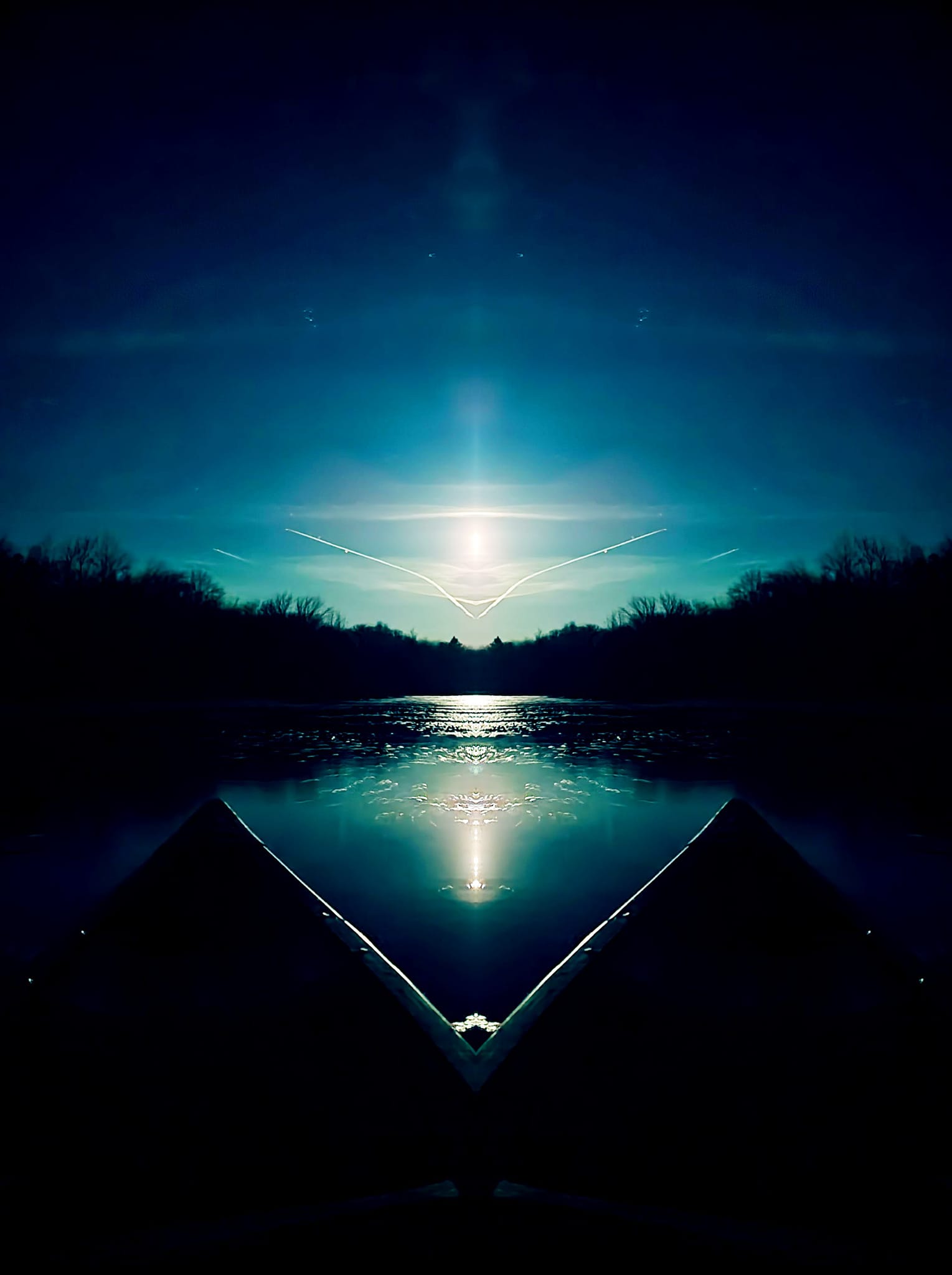 Sample of artist's photography: themes of water reflecting moonlight past the bow of a canoe.