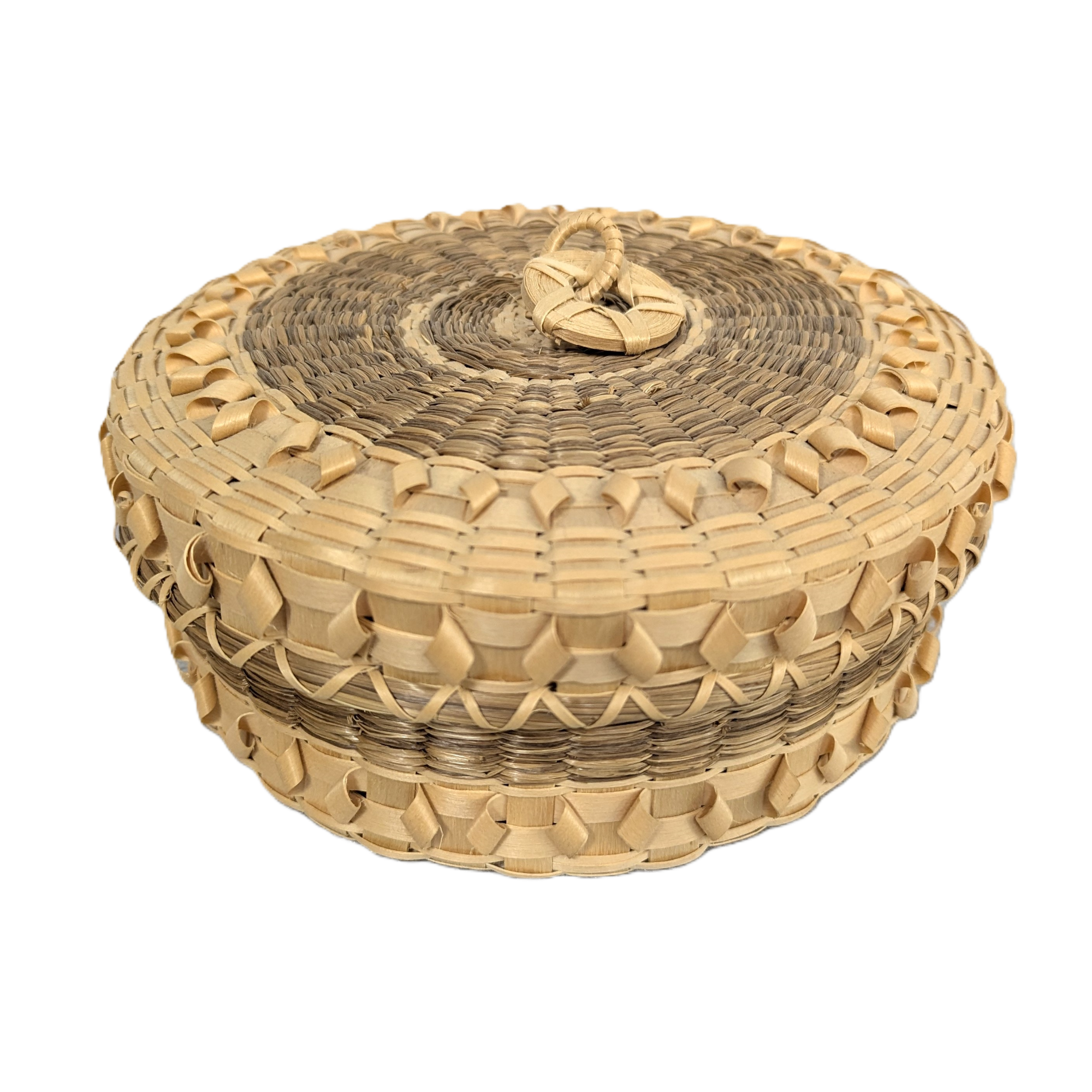 Image of round basket with sweetgrass and curls.