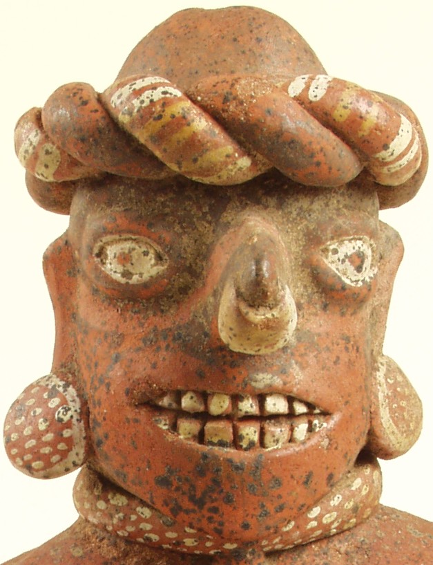 hm4113 Face of ceramic figure. Surface exhibits a generous scattering of dots and encrusted spots.