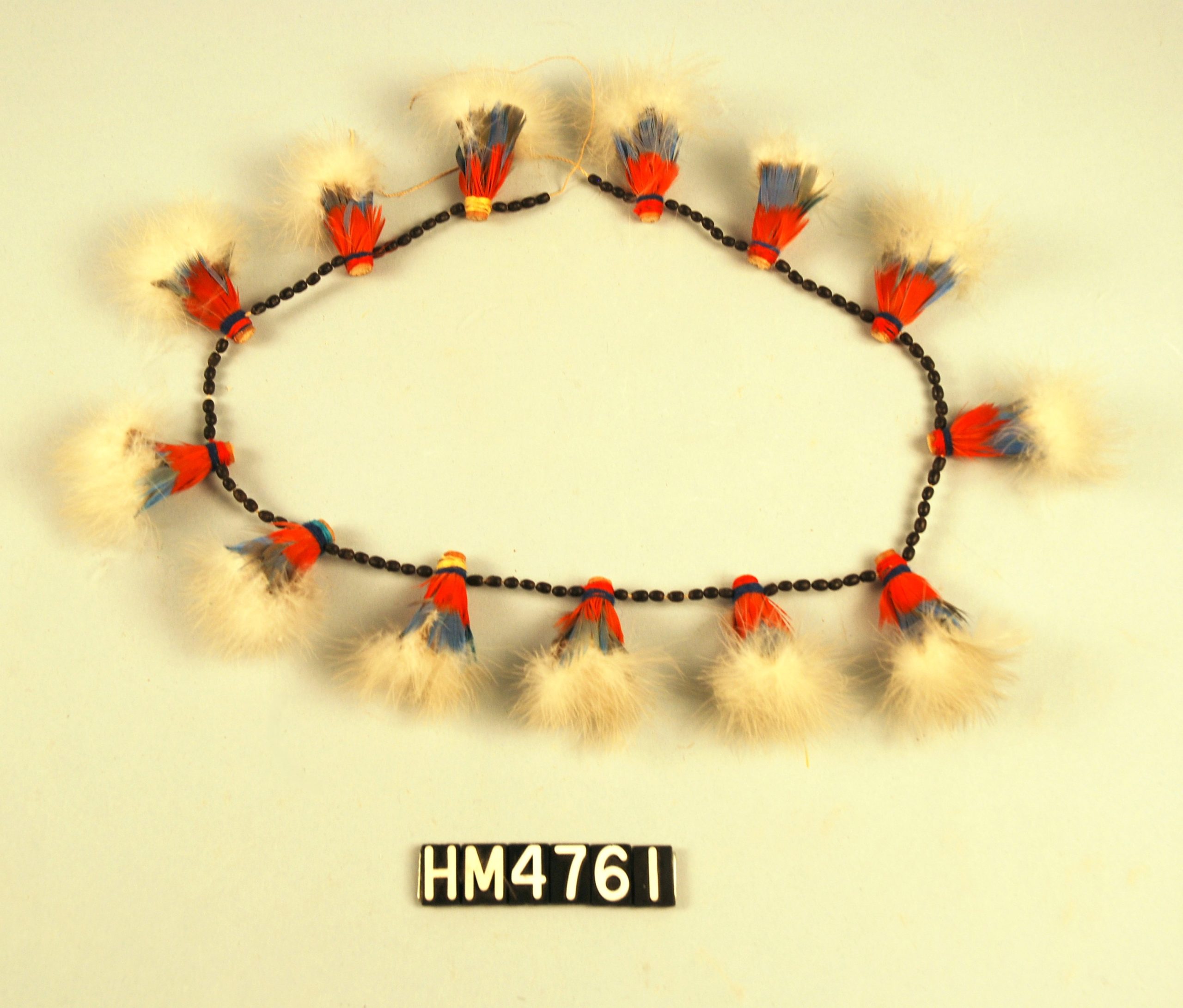 Image of a circlet made with tufts of feathers in white and red.