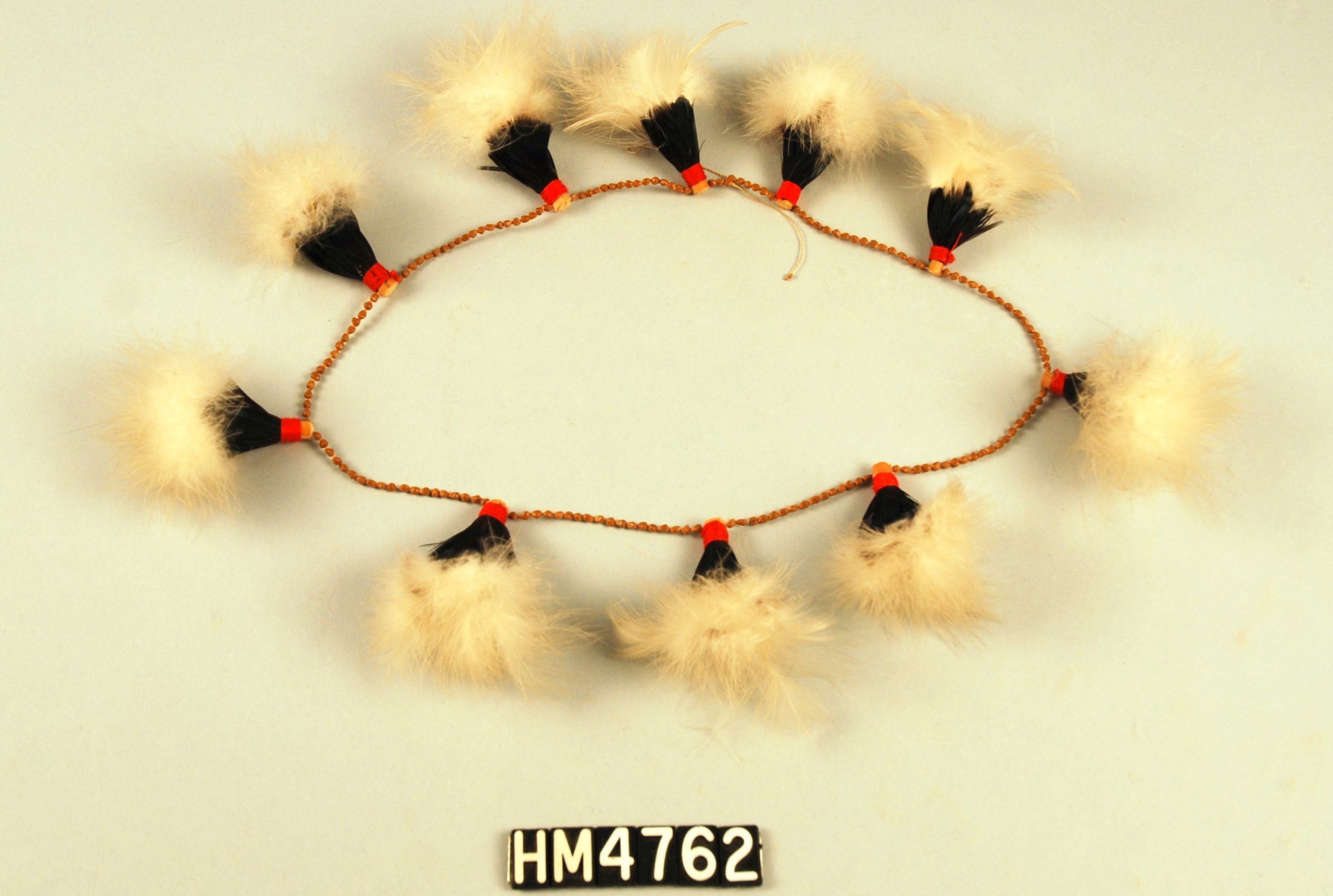 Image of a circlet made with tufts of feathers in white and black.