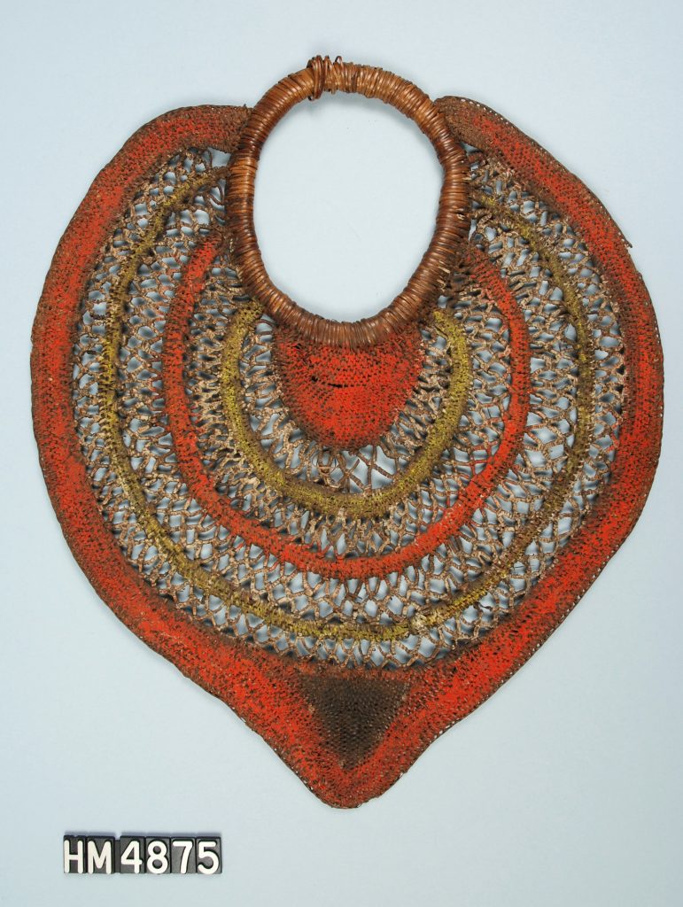 Image of a leaf-shaped object made of woven fiber with portions painted red.
