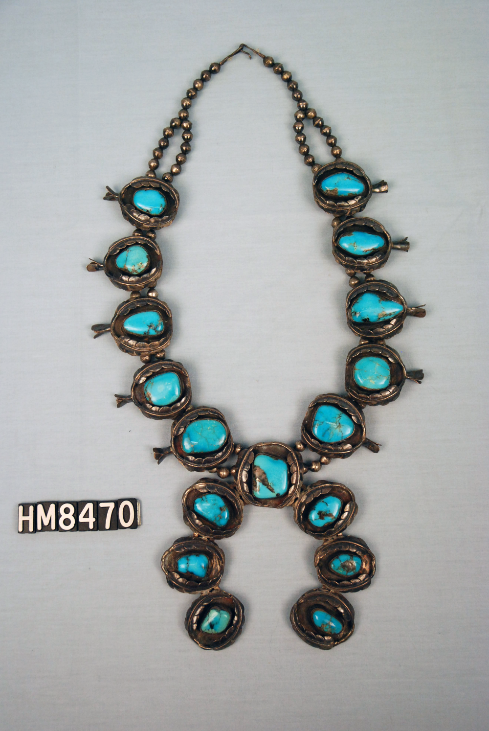 Image of a necklace with large turquoise elements set in silver.