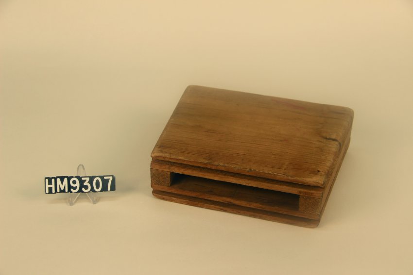 Image of rectangular wooden block used to weave baskets on.