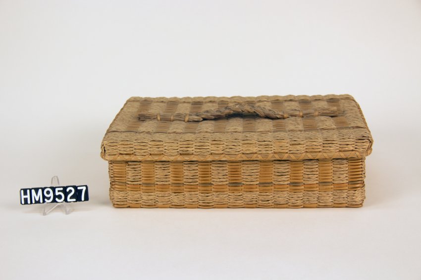 Image of a small rectangular woven basket equipped with a lid fit to close over the top.