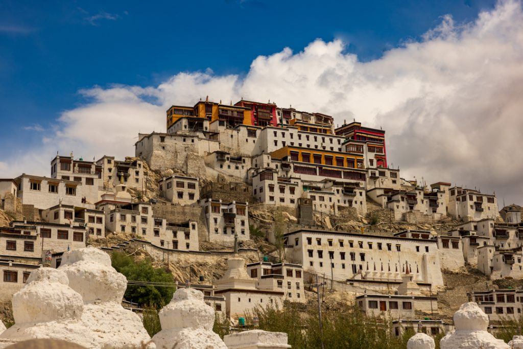 Sample of artist's photography: a brightly-lit neighborhood of tightly-packed, terraced buildings in cream and red.