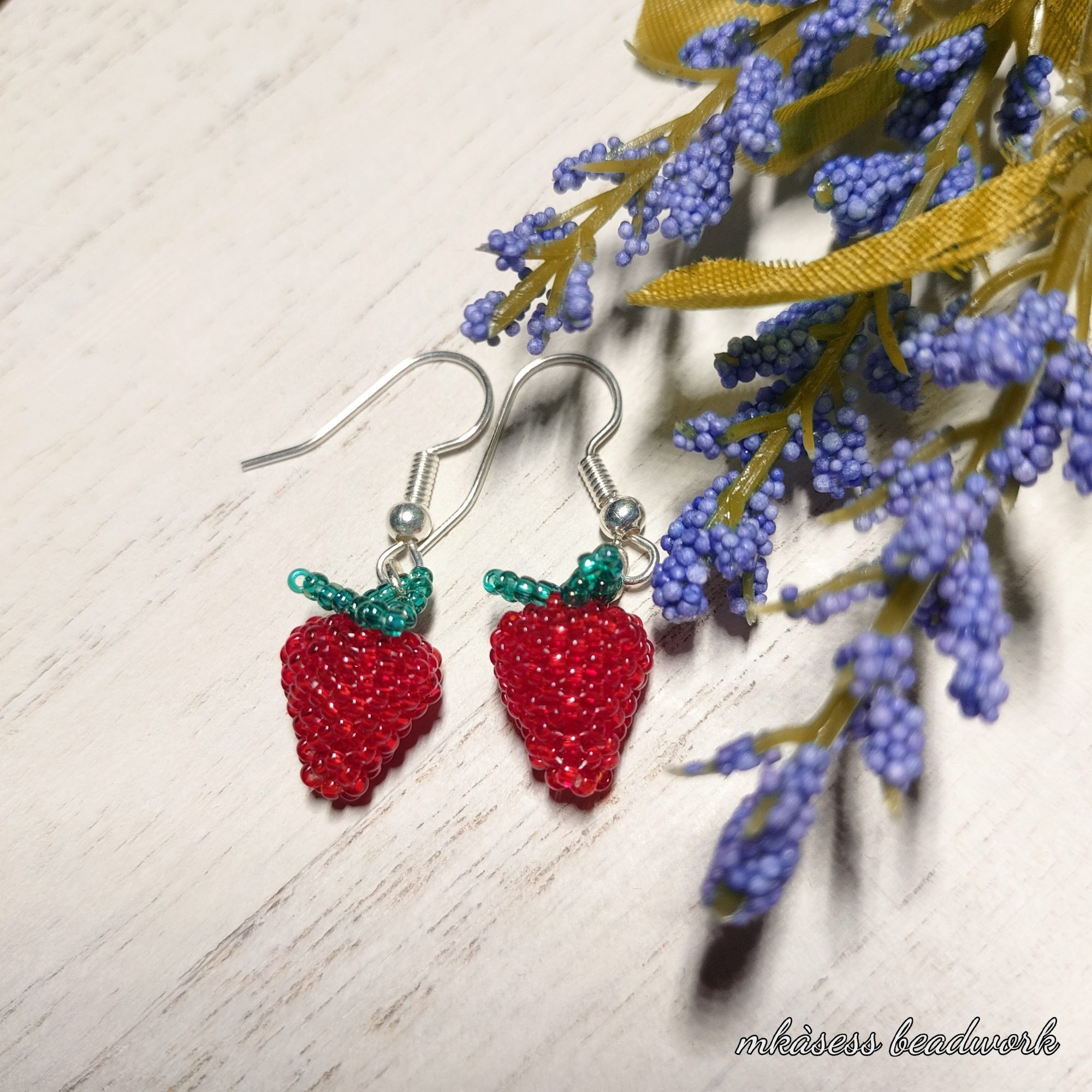 Image of dainty beaded earrings in the form of strawberries.