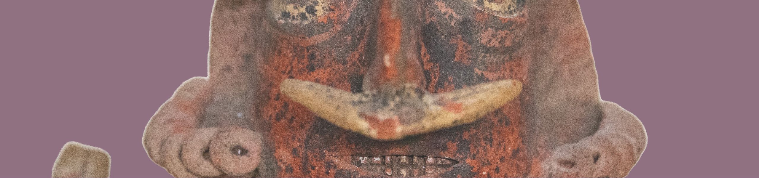 Detail image of the face of a ceramic figure with a septum ring.