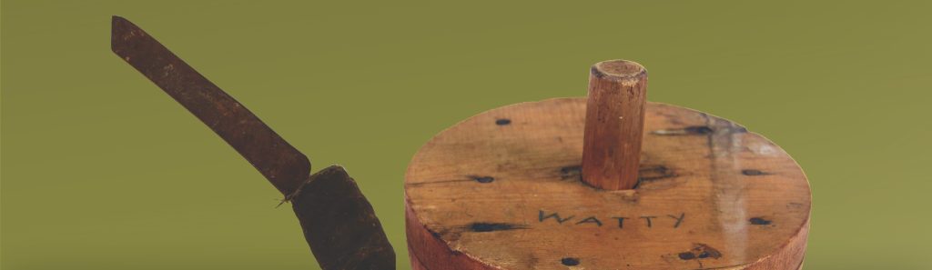 Image of crooked knife and wooden basket block with name "Watty" inscribed on it