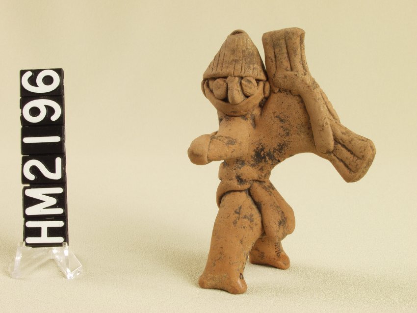 Tiny ceramic figure with elaborate costume.