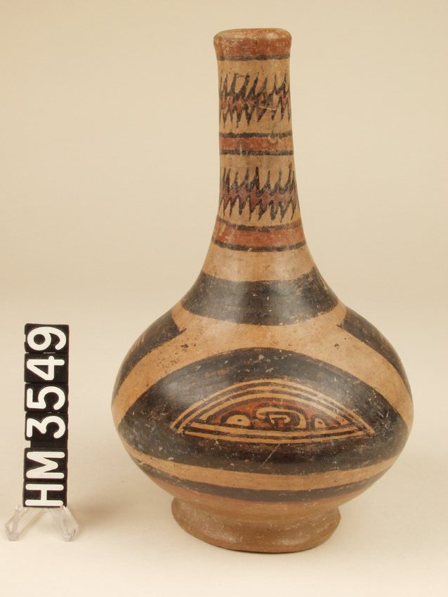 Polychrome ceramic bottle or tall-necked jar. Decorated with abstract head and tail panels as well as Y-element based claws on the side of panel in cream, black, and red.