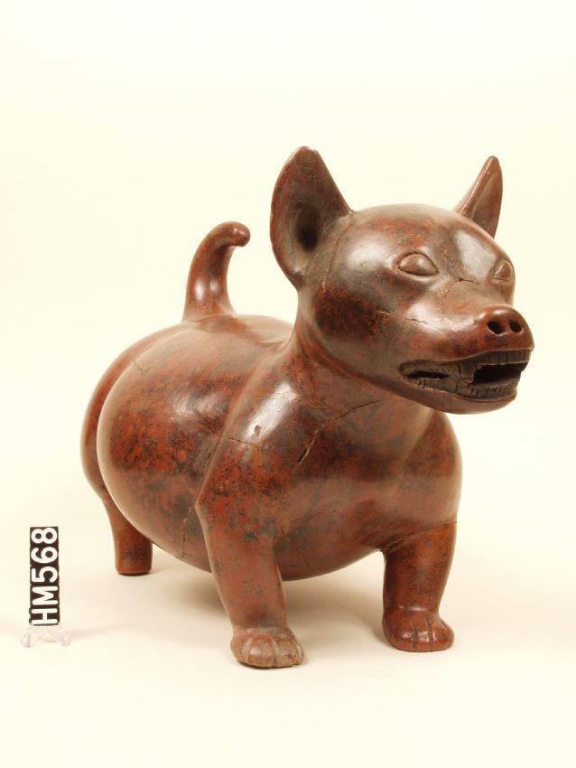 Ceramic figure of a dog with polished red finish.