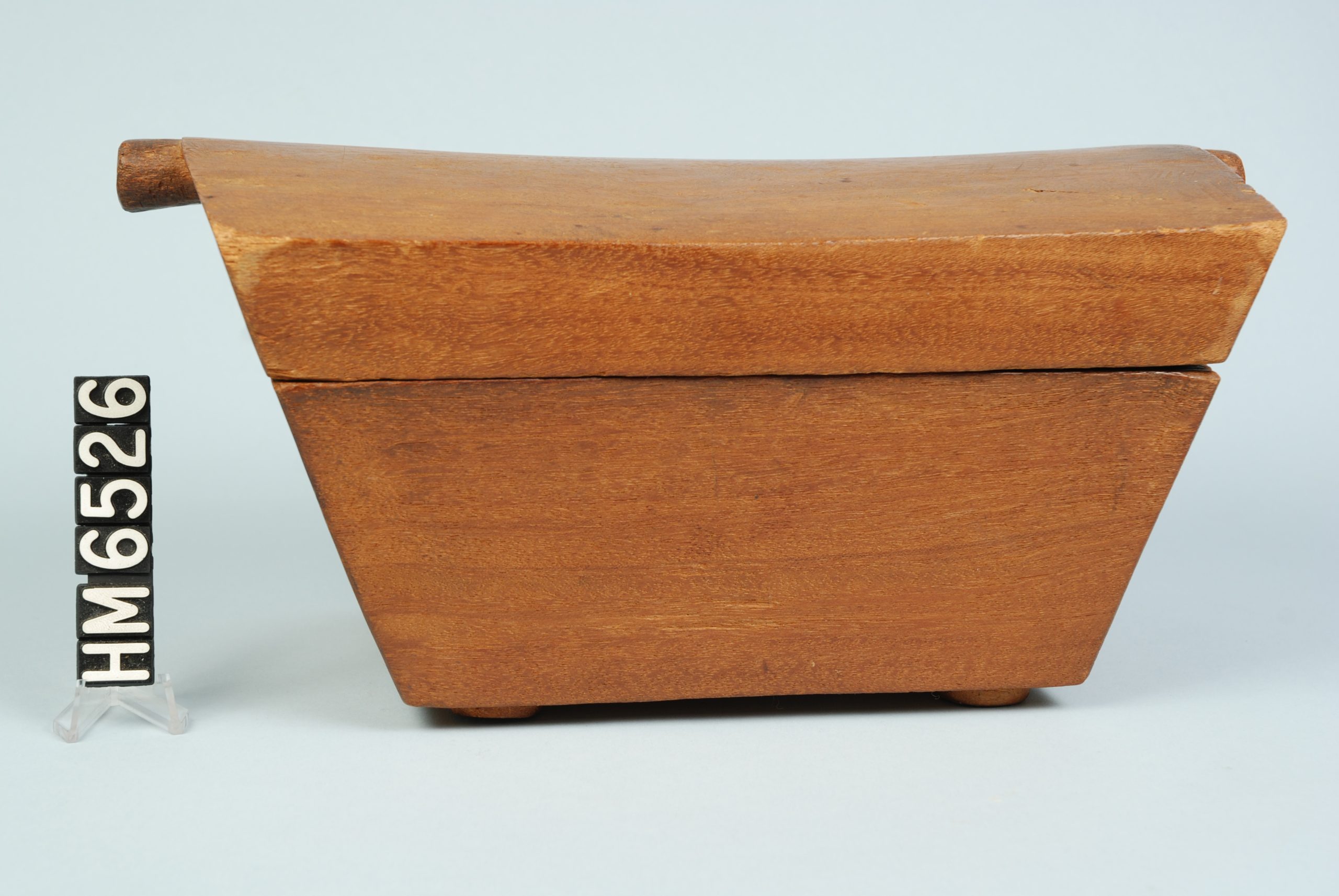 Image of a simple wooden box, narrow at base and expanding toward top.