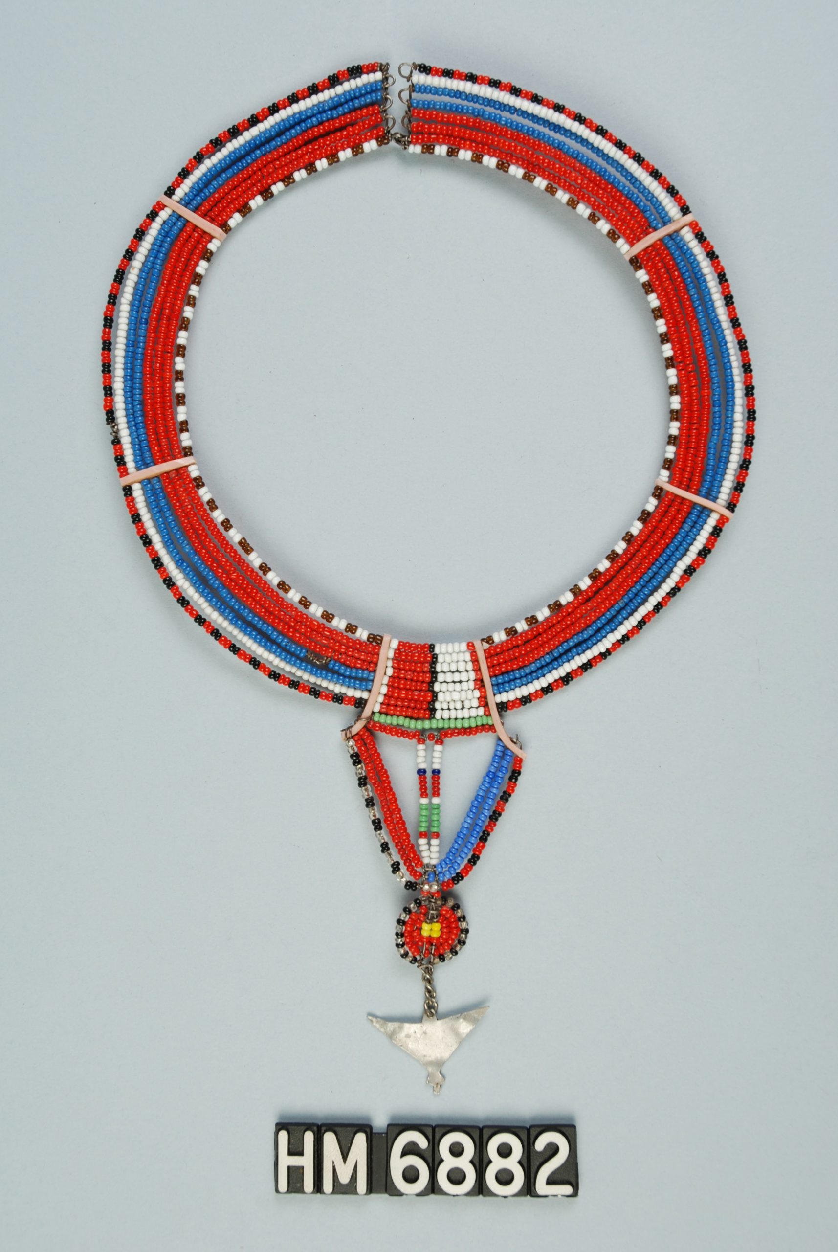 Image of stiff, circular beaded necklace with silver ornament.