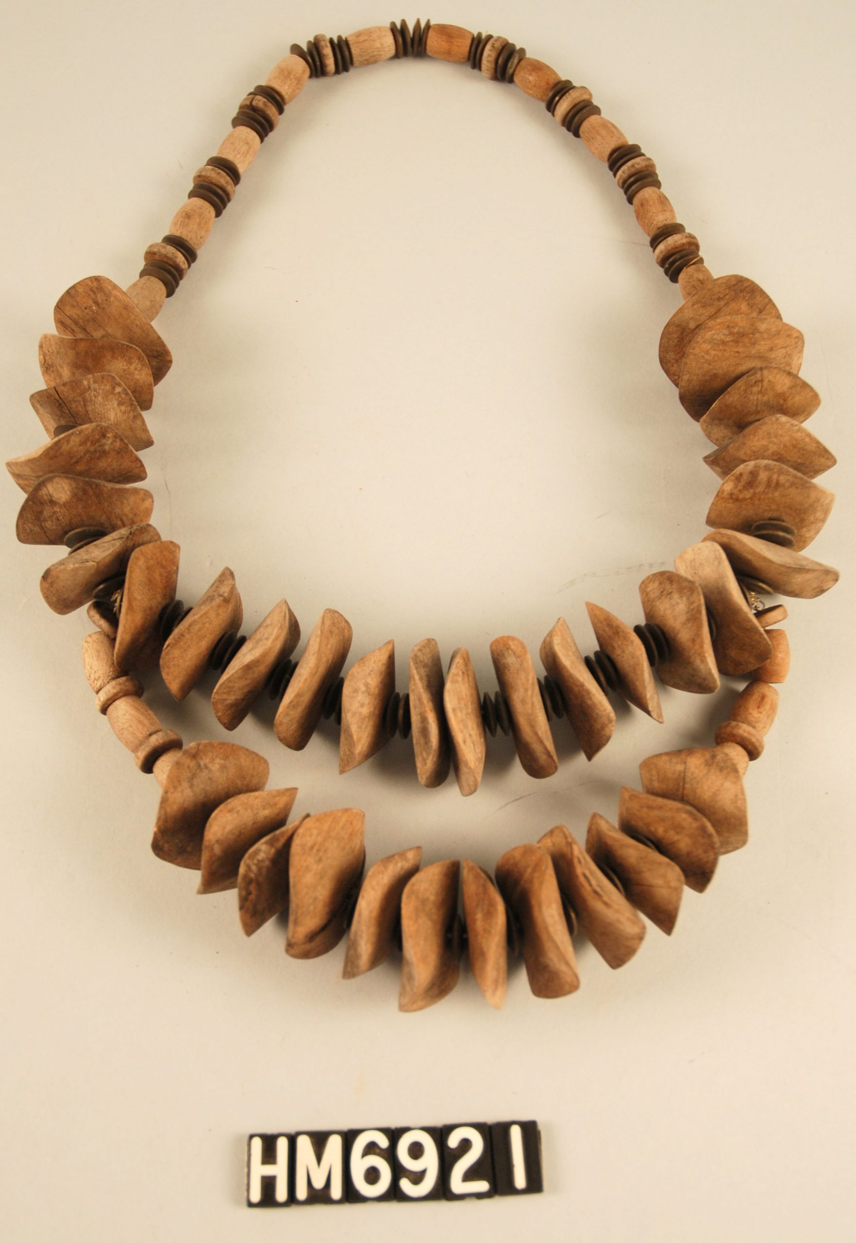 Image of necklace made with strung seeds or wooden beads.