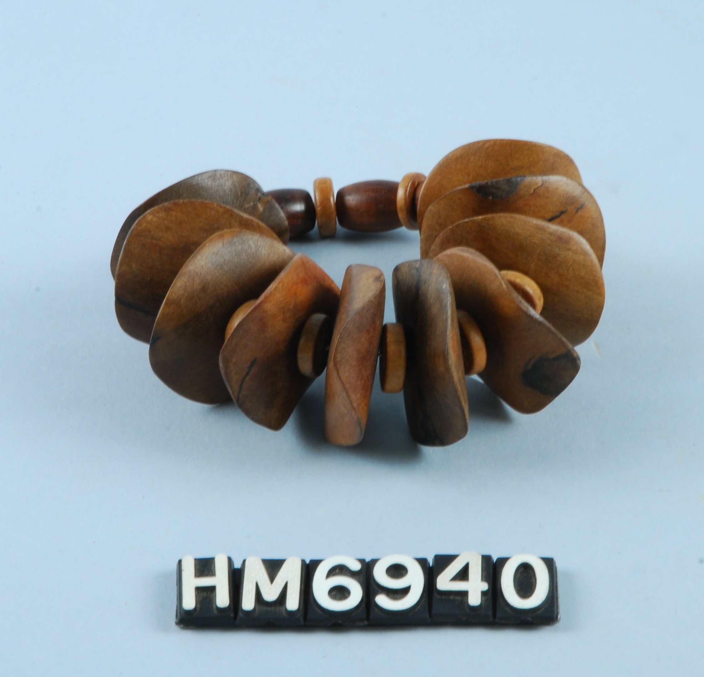 Image of bracelet made with strung seeds or wooden beads.