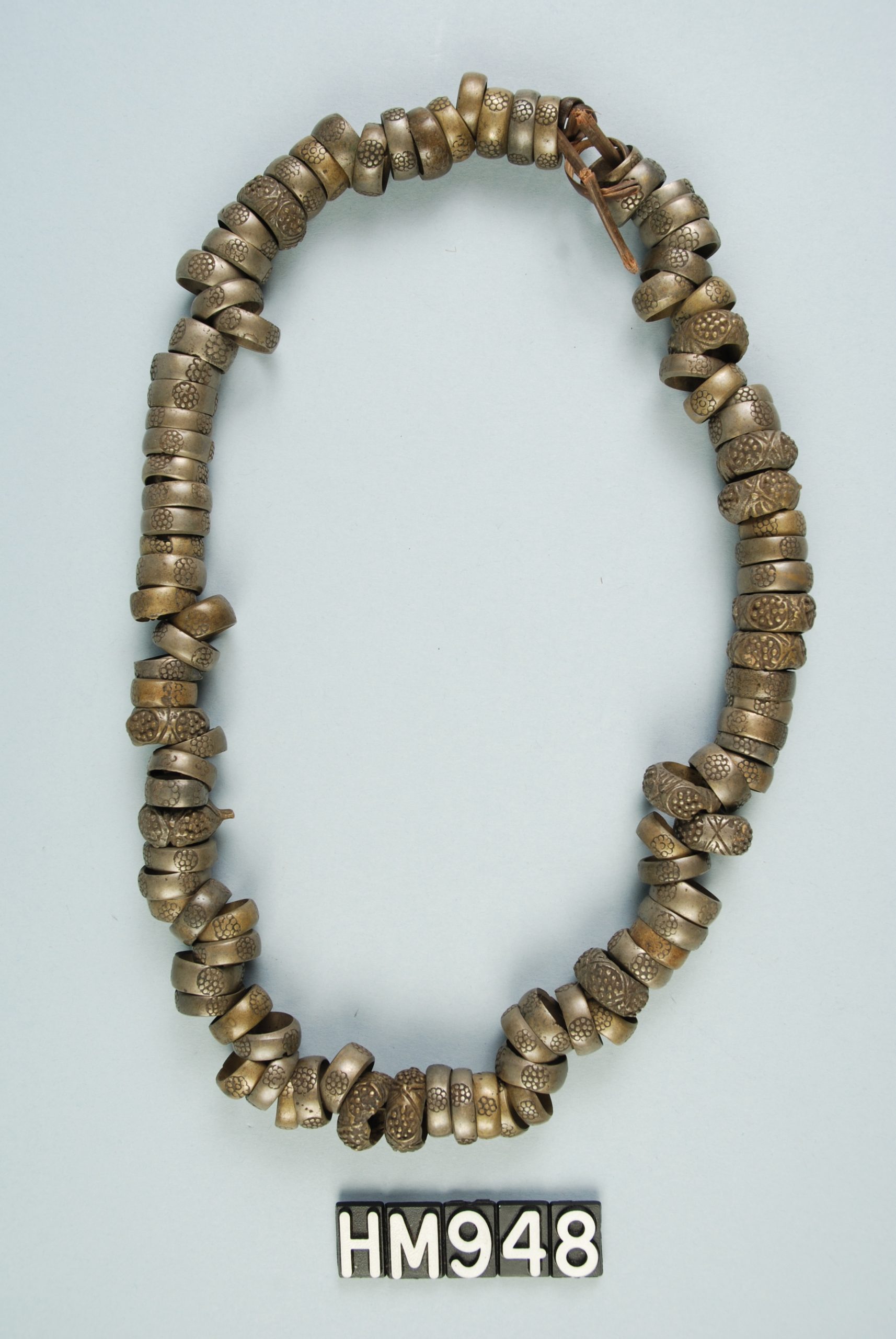 Single strand of copper rings with stamped flower design.
