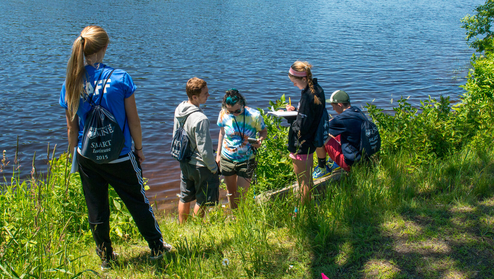 Institute participants standing next the the Stilwater River