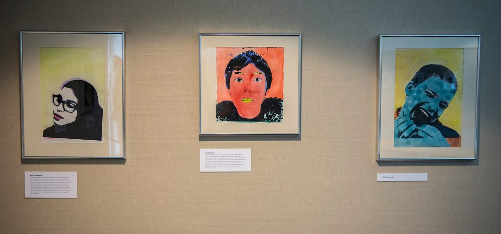 Warhol-inspired student portraits on a gallery wall