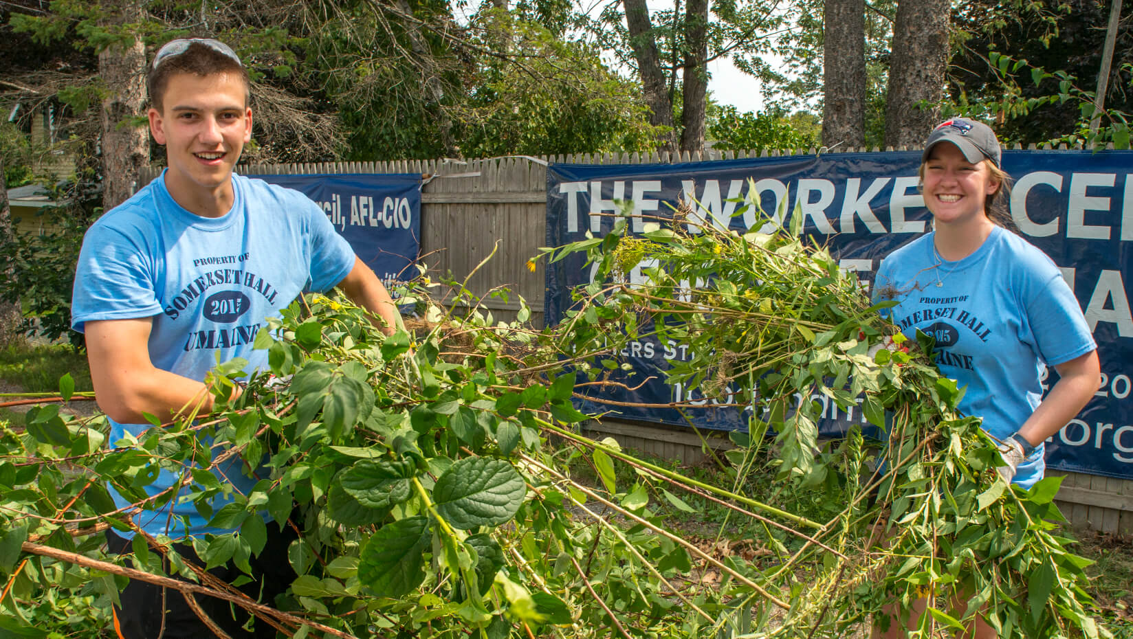 Student volunteers remove plants