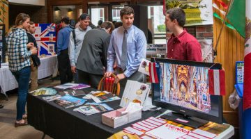 Business School students standing with their displays at the 2016 International Trade Show