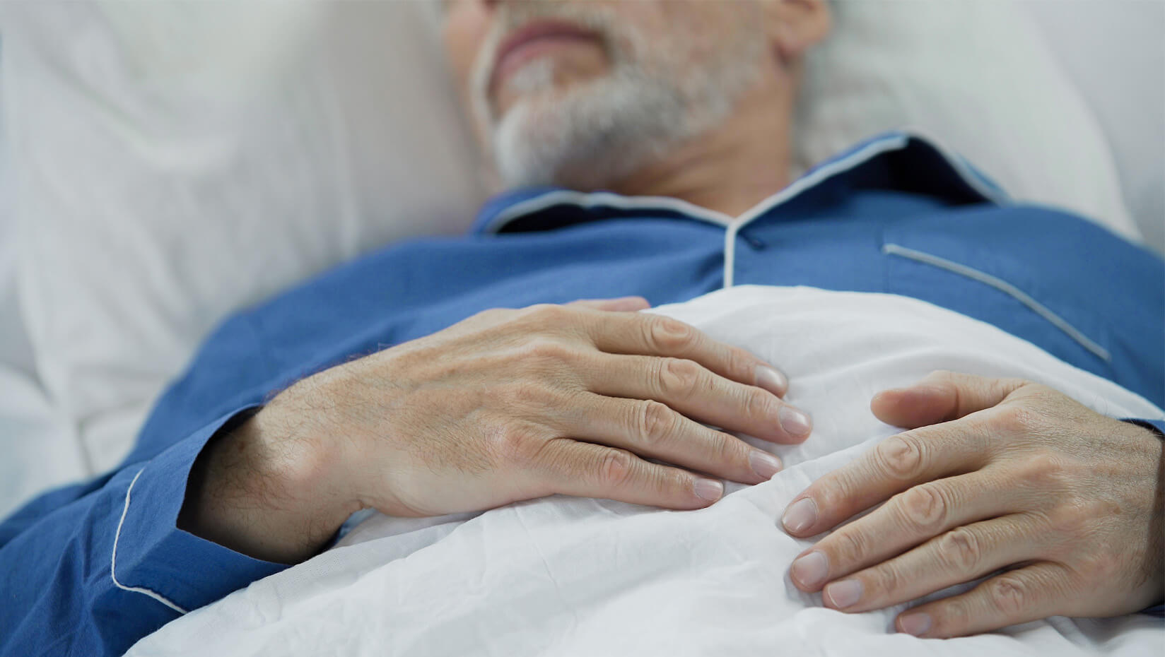 Elderly man in bed
