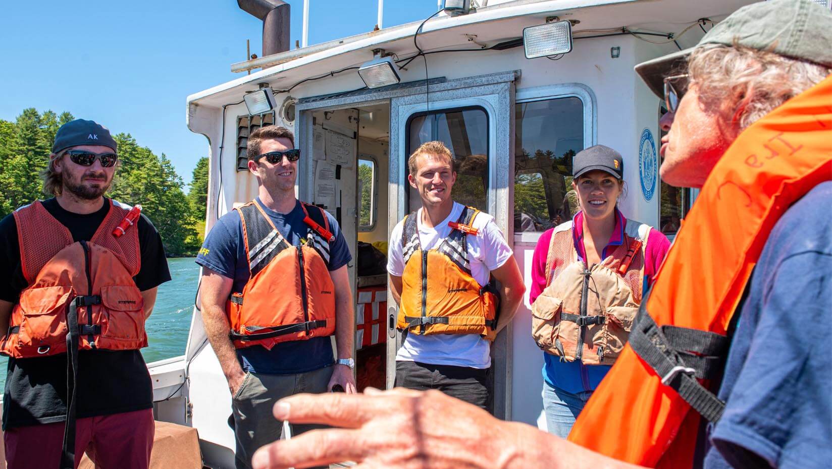 Students and a professor on a boat