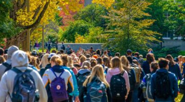 A photo of students walking along UMaine's Mall