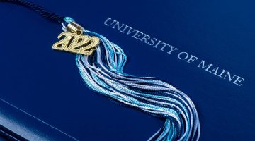 A photo of a UMaine diploma cover and tassel