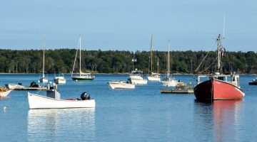 A photo of boats in a harbor on the coast of Maine