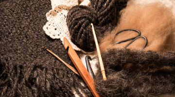 a decorative pile of fibers and crocheting supplies