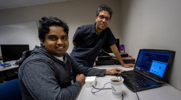 Photo of Nimesha Ranasinghe and Chamath Amarasinghe with the SipBit device.