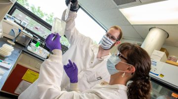 A photo of two people in a lab