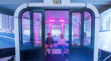 A photo of people sitting in a VEMI Lab simulator