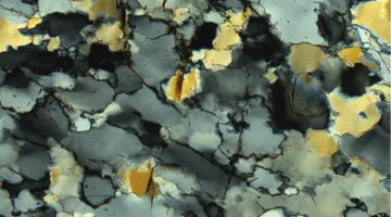 A photo of quartz grains as seen through a microscope