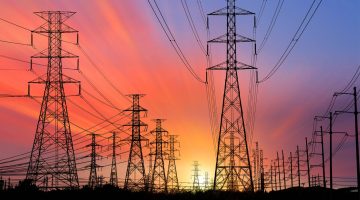 A photo of an electrical grid at sunset