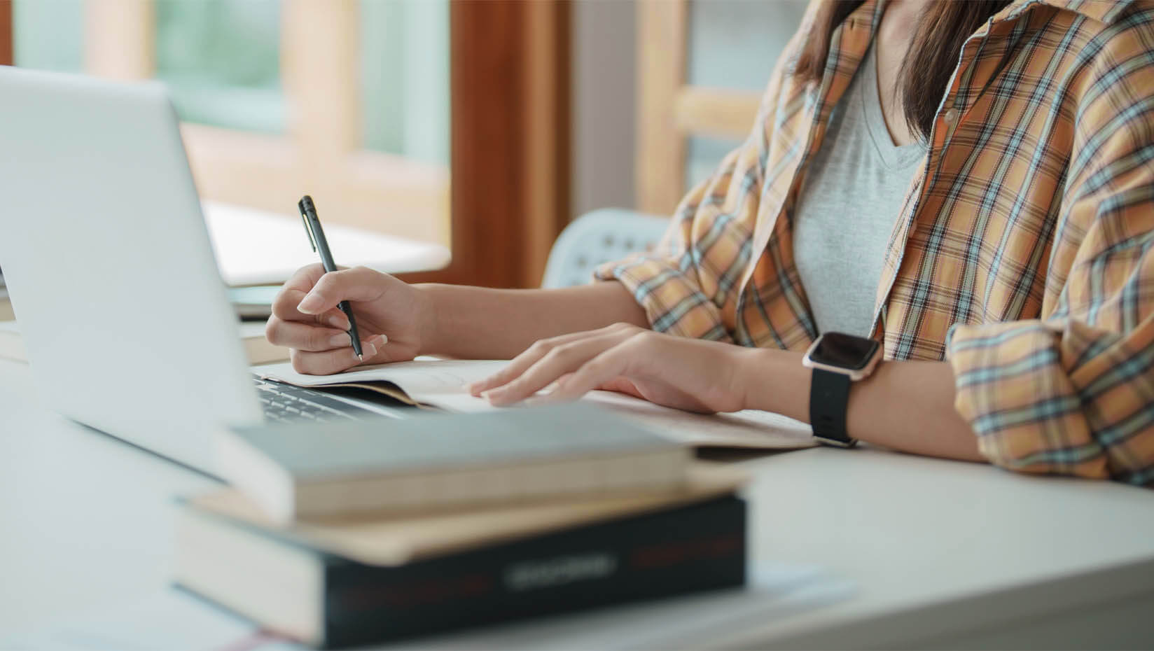 A photo of a woman studying at a computer