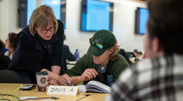 University of Maine President Joan Ferrini-Mundy helps a student with their coursework during a mathematics class in early 2020. Photo courtesy of the University of Maine.