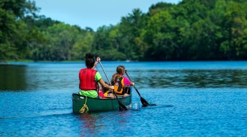A photo of two people in a canoe on a river