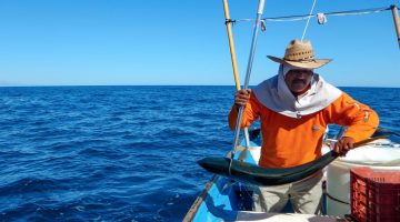 A fisherman in a boat on the ocean