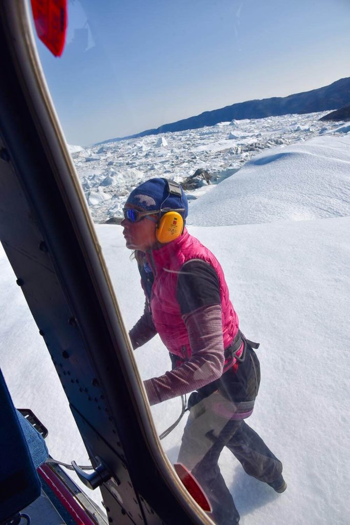A photo of a person getting into a helicopter