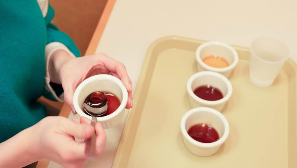A photo of a person hold a cup of maple syrup