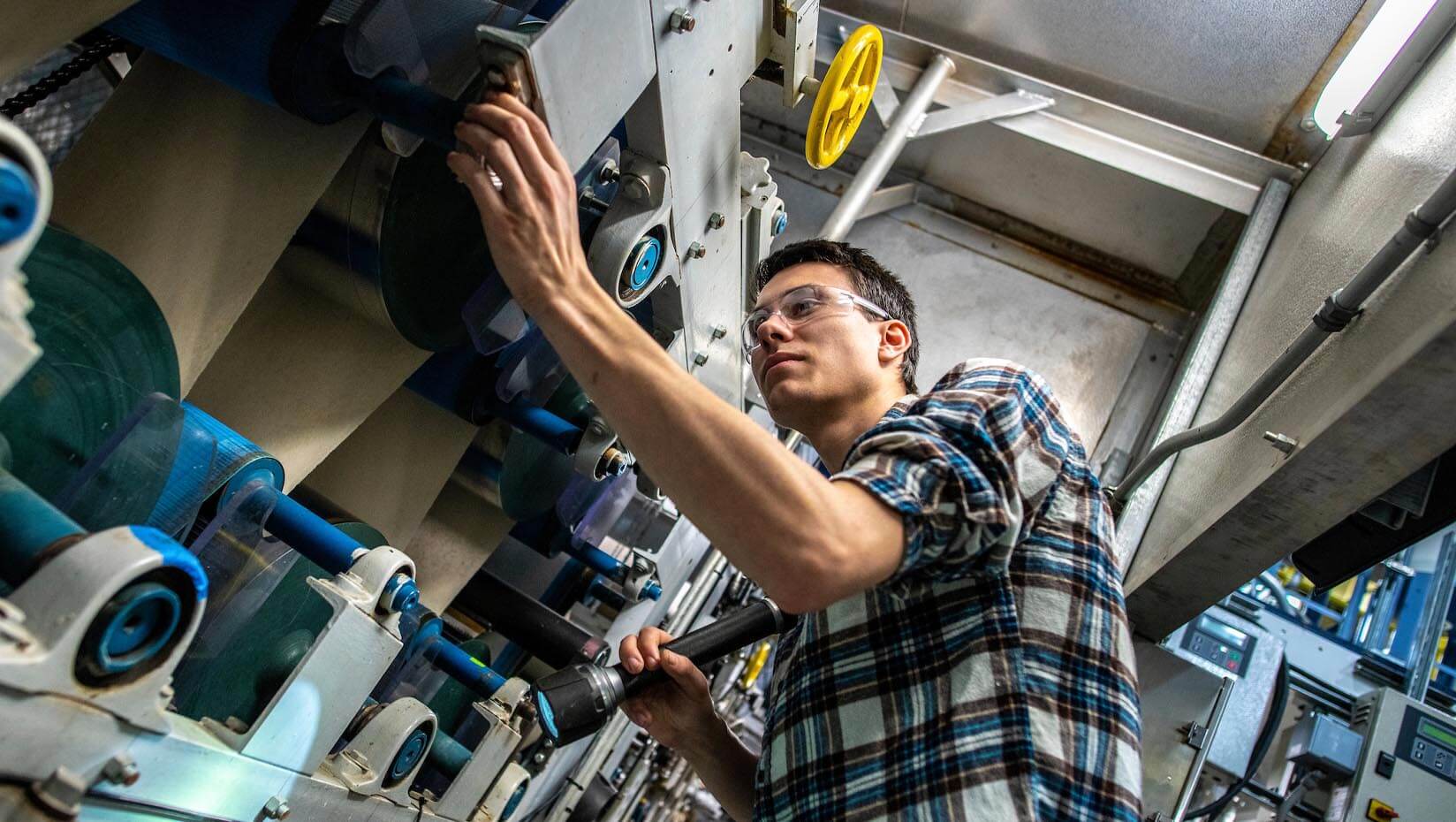 A photo of a person looking at a large piece of machinery