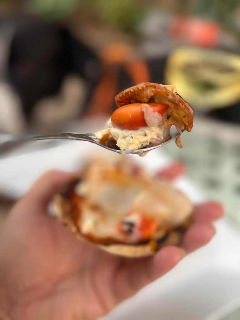 A photo of scallops on the half shell.