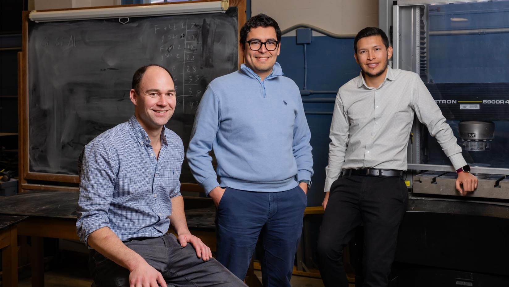 A photo of three people in a lab